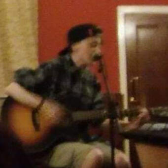 Picture of Jay A blurry photo of Jay performing at an open mic night